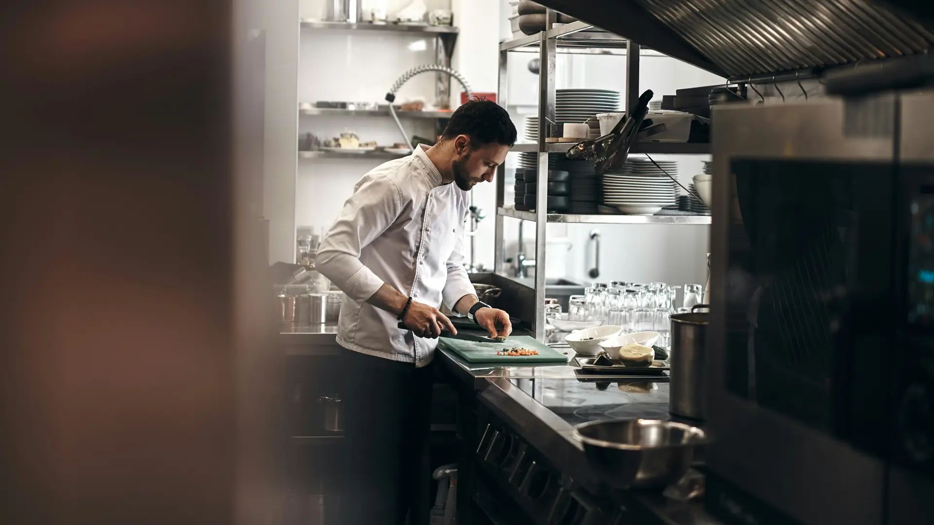 A chef working the pass in a professional hotel kitchen
